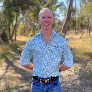 Bachelor of Agriculture student Matthew McCauley in rural setting in UNE shirt