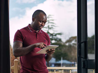 UNE student uses tablet in outdoor setting