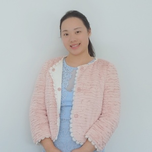 Bachelor of Urban and Regional Planning graduate Shili Wang in pink jacket at home