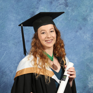UNE graduate Molly Northcott in cap and gown on graduation day