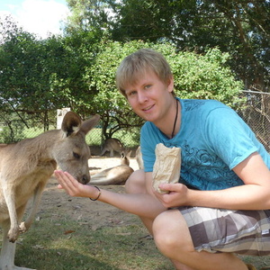 UNE graduate feeding kangaroo